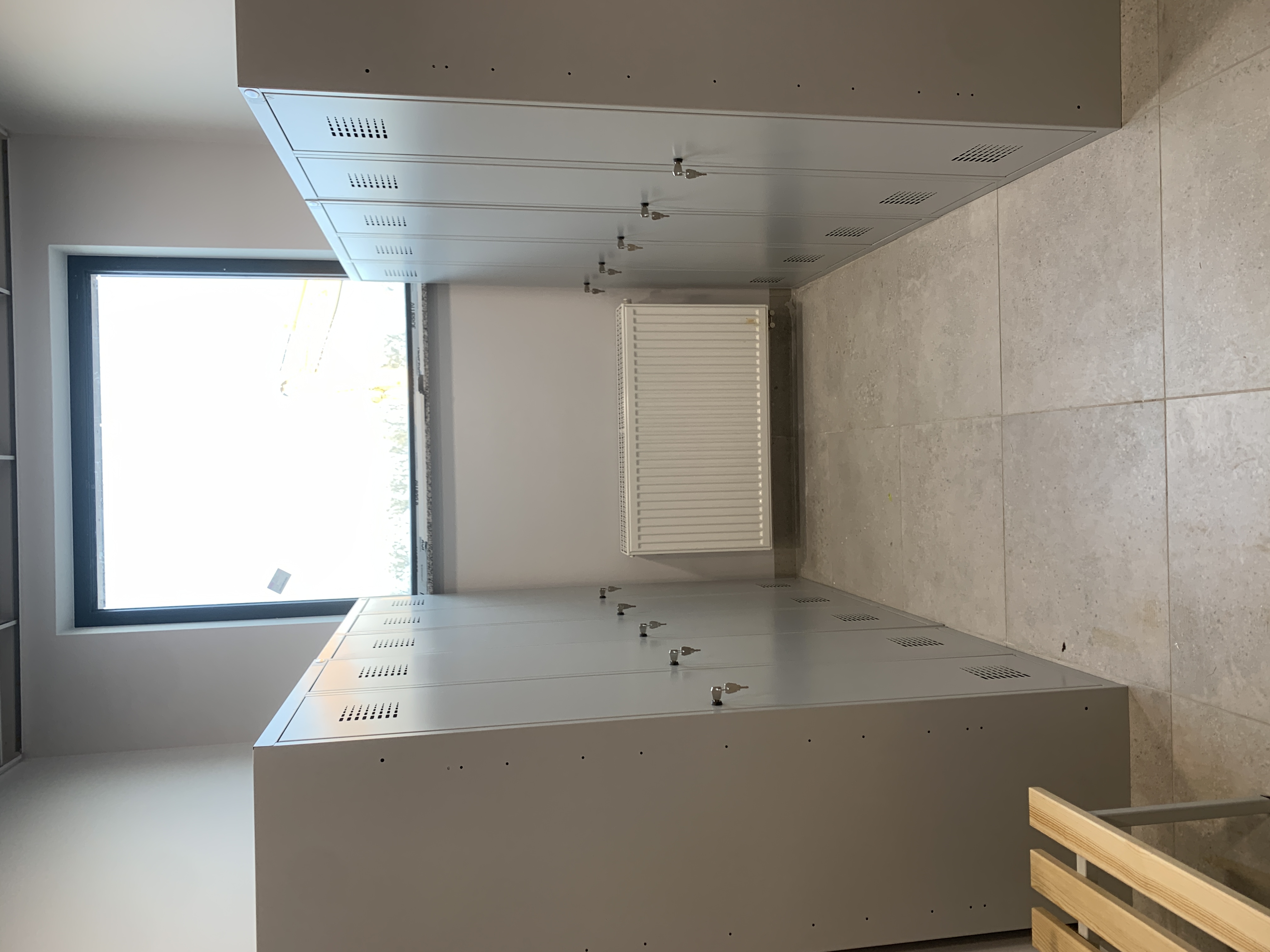 Szatnia pracownicza z metalowymi szafkami ubraniowymi SUM 420 W ST 80 cm z przegrodą oraz ławką 160 cm, RAL 7035 – realizacja Pozmebel Szczecin